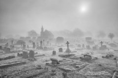 Moody image of chapel and cemetery in mist