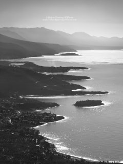 Black and white photograph showing the dramatic coastline of the Mani peninsula in Greece