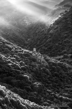 Shafts of morning sunlight lighting the Kitriniaris Tower in the Mani