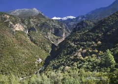The Sotiris Monastery in the colourful Viros Gorge with snow-capped mountains in southern Peloponnese