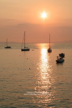 Boats anchored in the Mediterranean at sunset